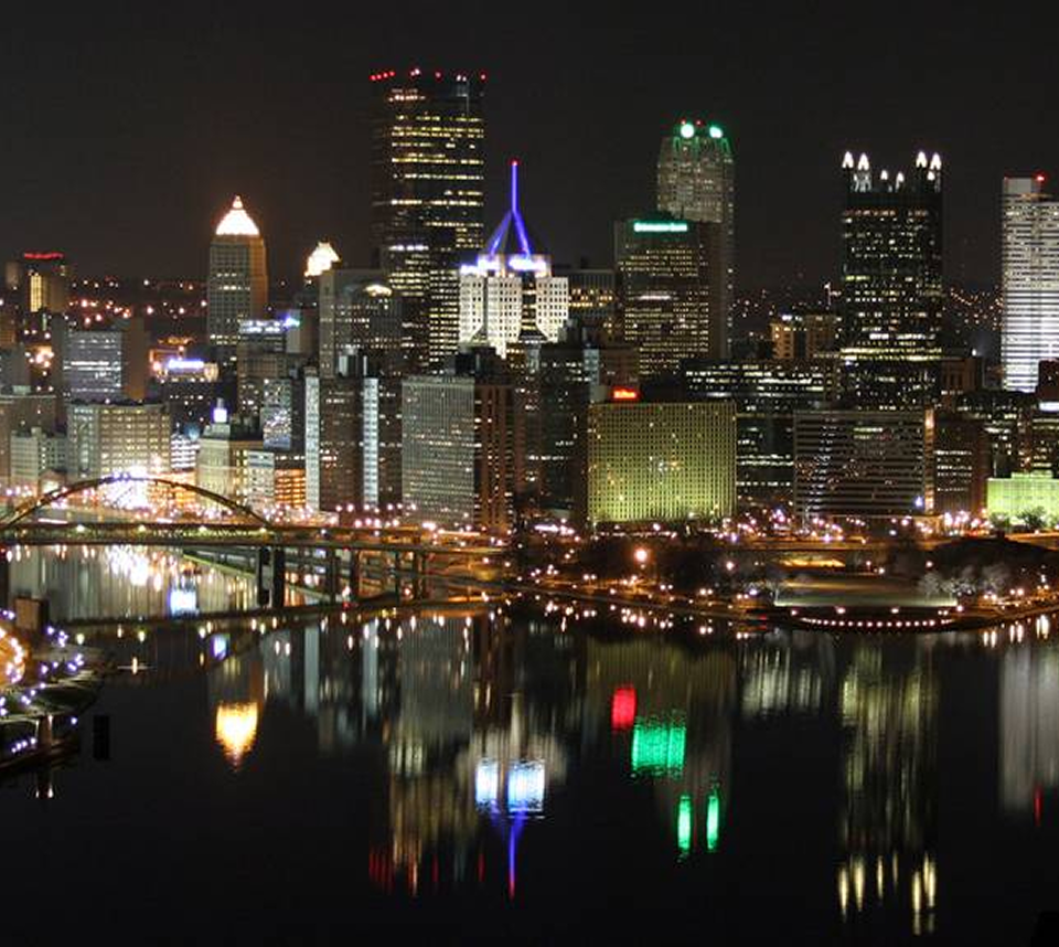 City skyline with illuminated buildings at night.