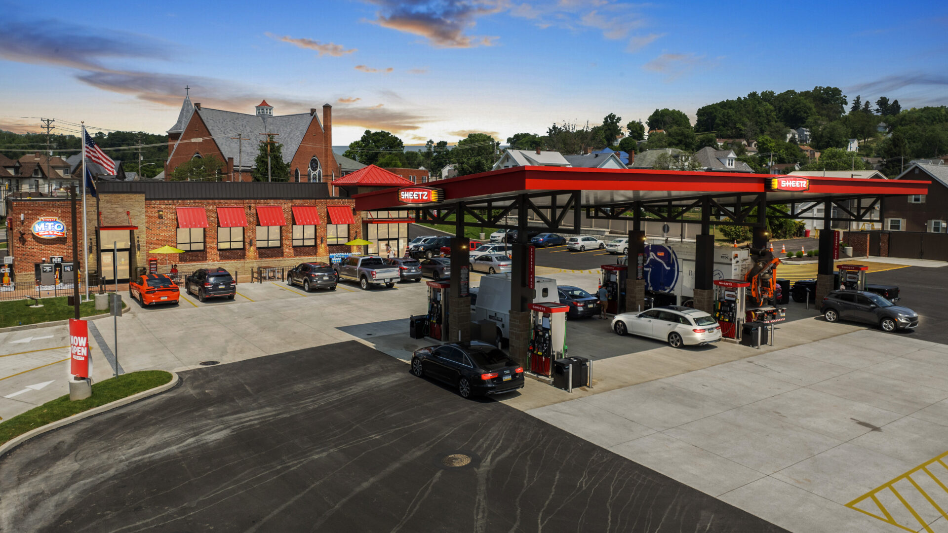 Gas station with convenience store and vehicles.