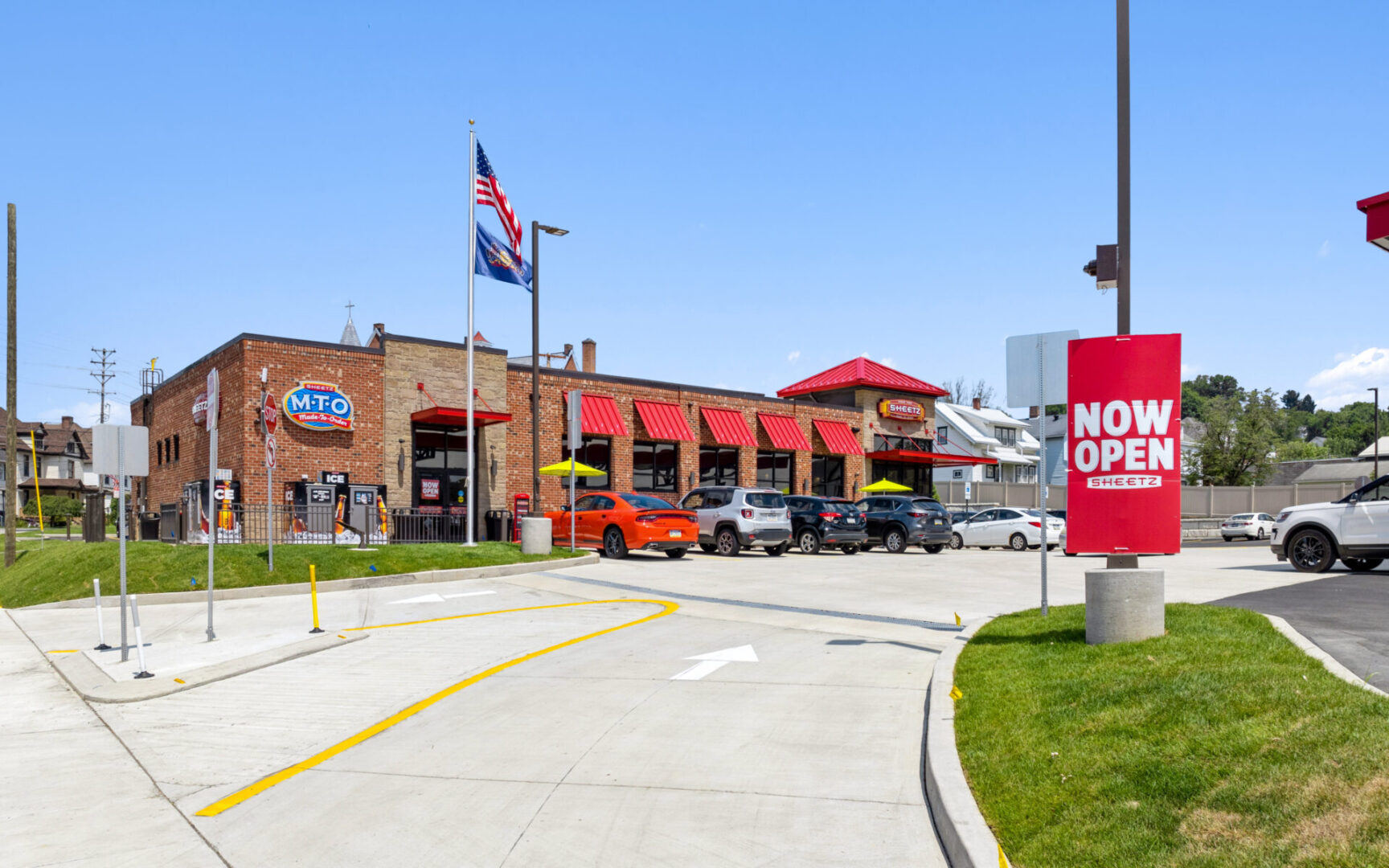 Restaurant exterior with "Now Open" sign.